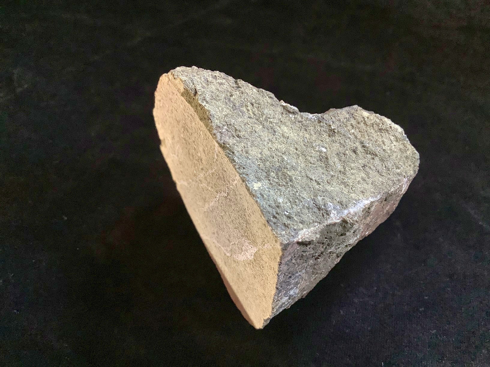 Hand specimen of microgabbro on black background