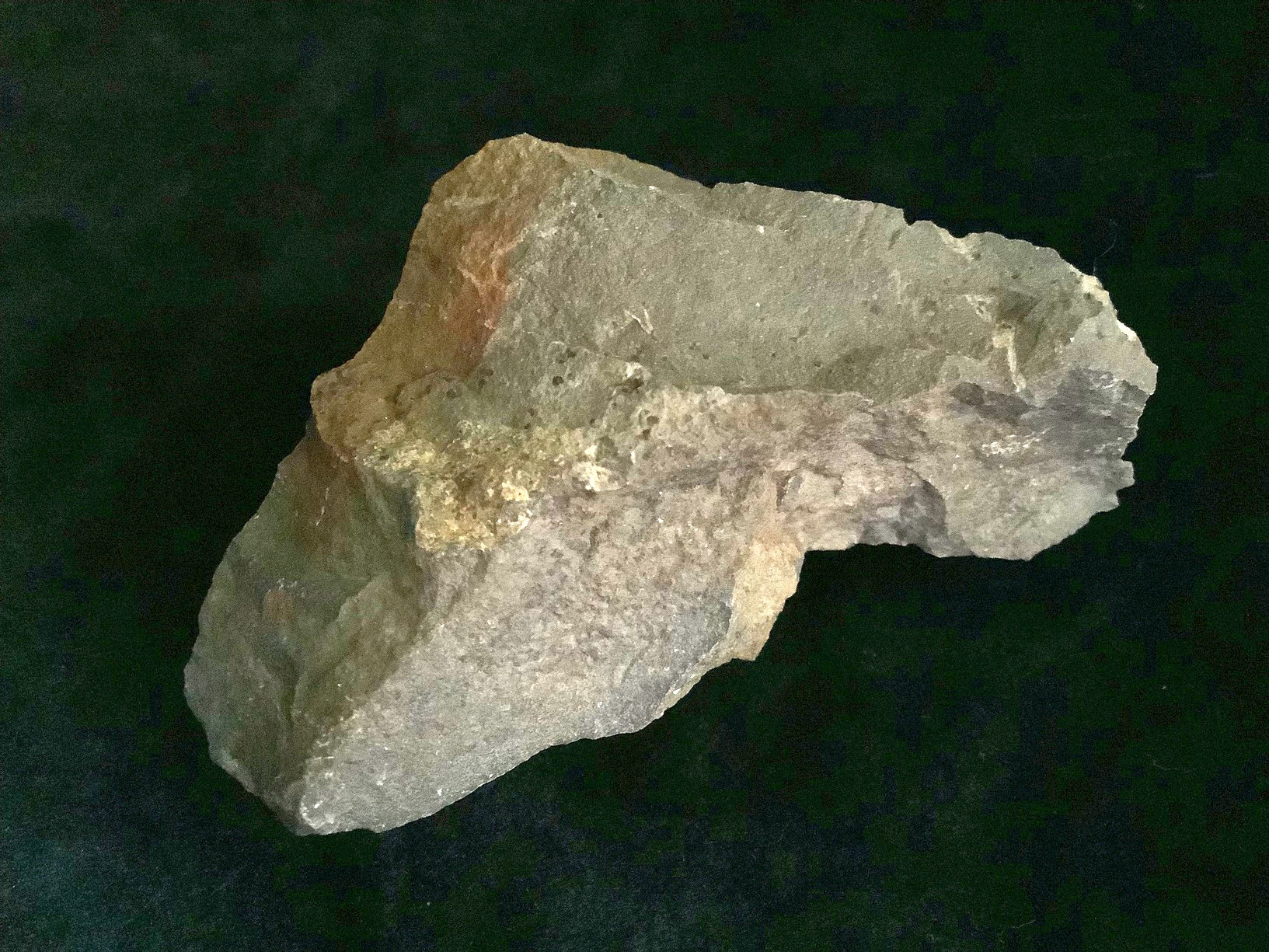 Hand specimen of sandstone on black background