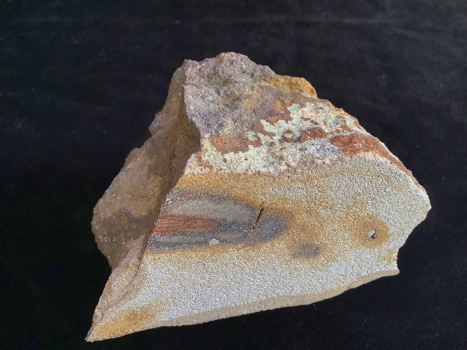 Hand specimen of sandstone on black background