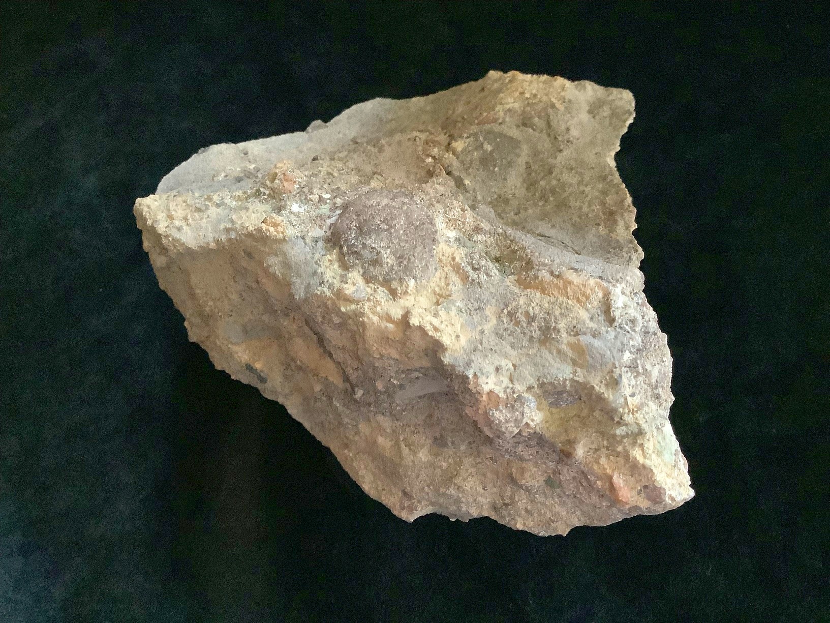 Hand specimen of sandstone on black background