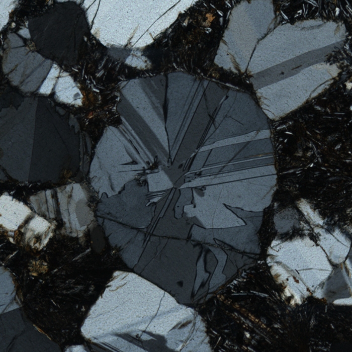 Image under crossed polars of a cordierite grain showing cyclic twinning