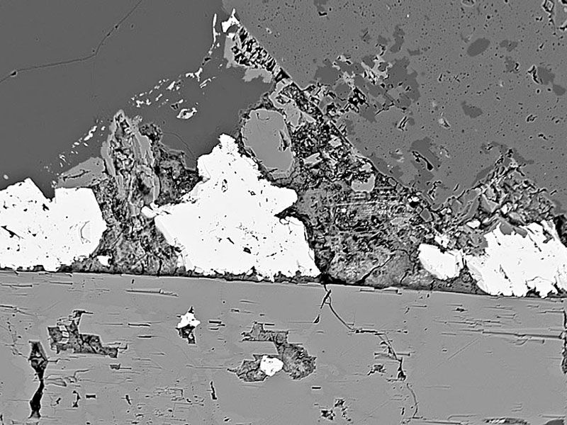 Three crystals of bazirite on riebeckite - width 700 microns